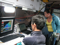 Students watch monitors in the lab aboard a research vessel.