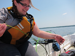Student examines a strand of eelgrass on Great Bay.