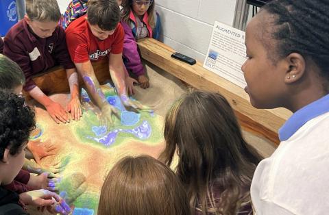 School kids play in the bathymetric sandbox on Ocean Discovery Day