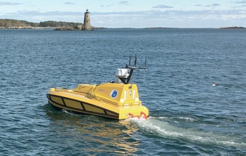 Yellow BEN ASV with lighthouse in the background.