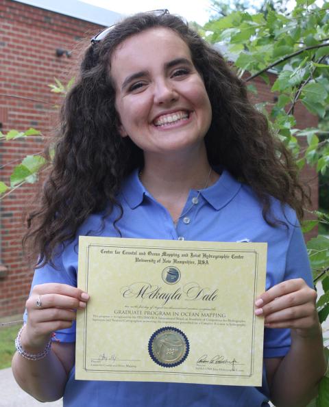 Mekayla holds her Cat A Certificate