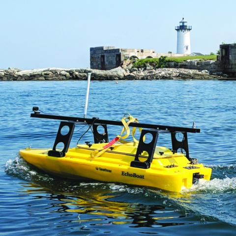 Echoboat steaming past  white lighthouse
