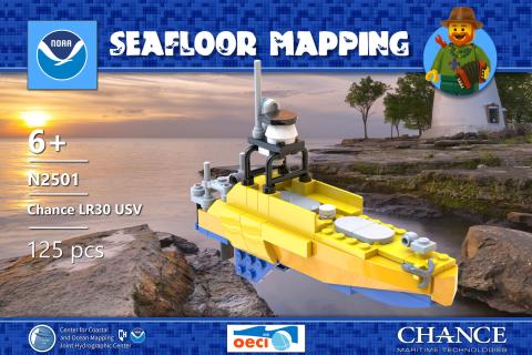 Mockup of Lego kit box cover showing the completed ASV model on a background photo of a lake shore at sunset.